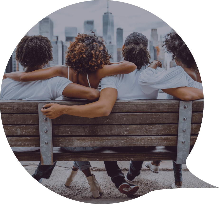 group of women sitting on a bench